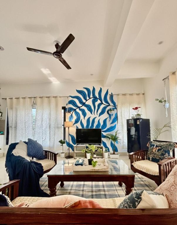 a living room with a couch and a table at The Little Idyll in Dharmsala