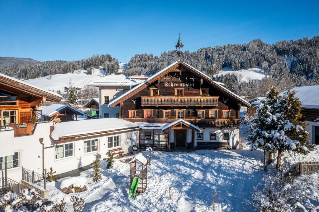 an image of a lodge in the snow at Pension Schrempfgut in Flachau