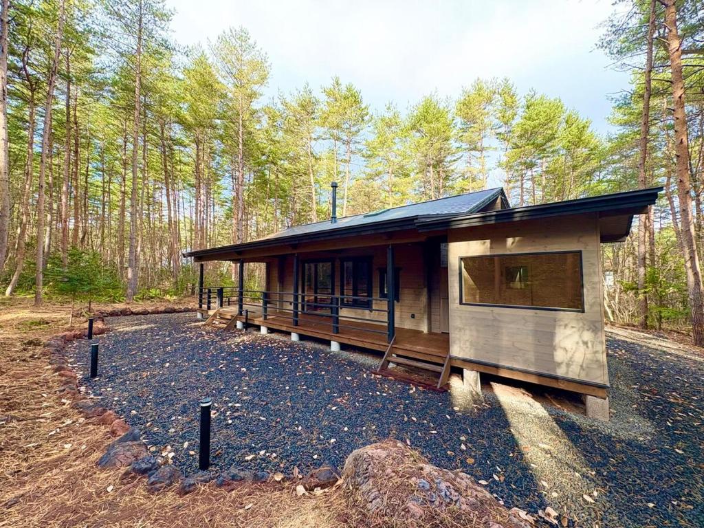 a small cabin in the middle of a forest at Second House LUONTO in Tsumagoi