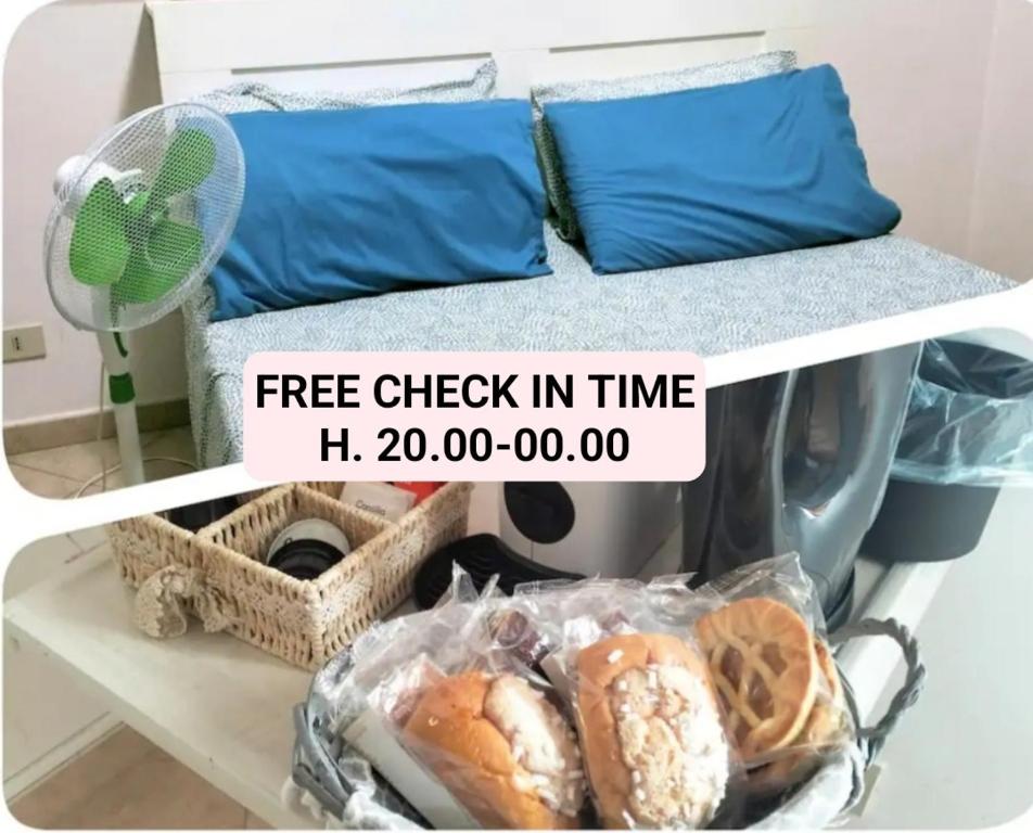 a shelf with a bed with bread and a sign that reads free check in time at La Perla B & B in Ciampino