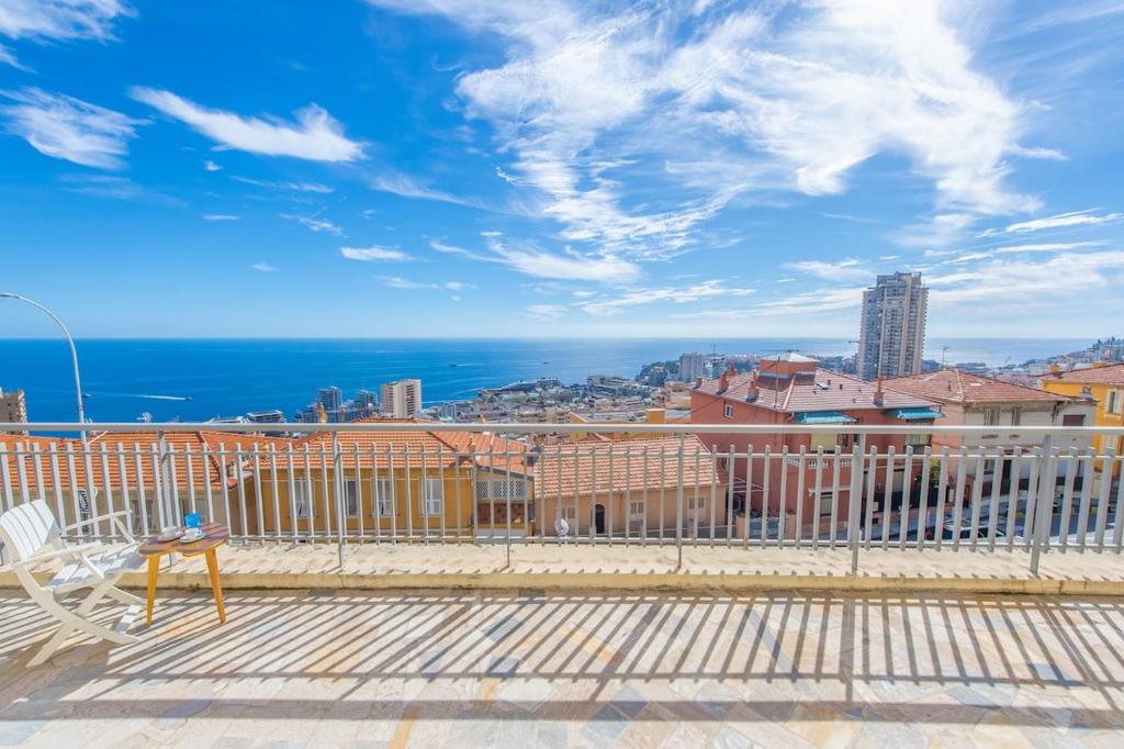 a balcony with a view of the ocean and buildings at New Panoramic studio overlooking Monaco in Beausoleil