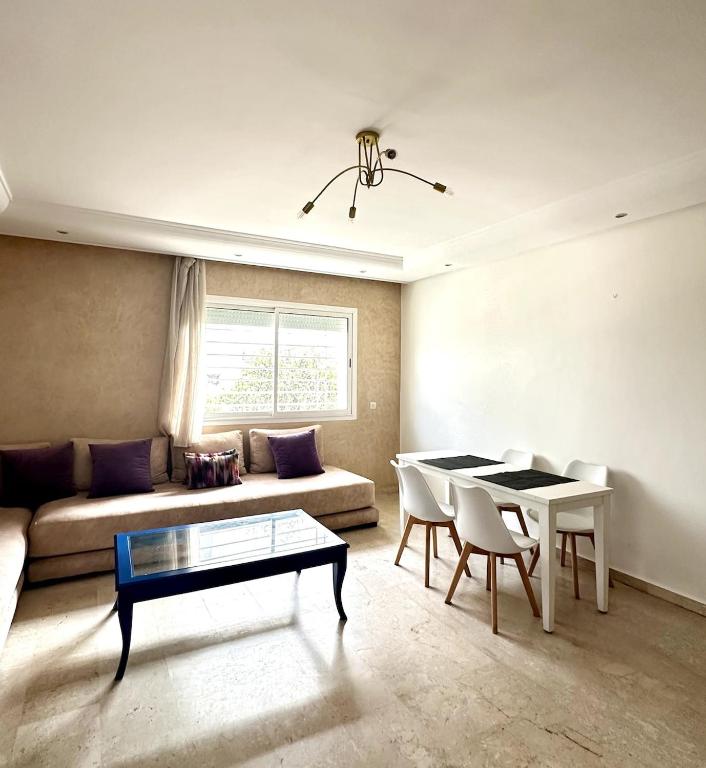 a living room with a couch and a table at La Perle Aïn Diab Beachfront in Casablanca