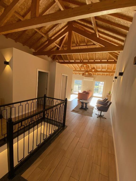 a living room with wooden ceilings and a piano at Casa dos Camilos - Douro View Terrace House in Peso da Régua