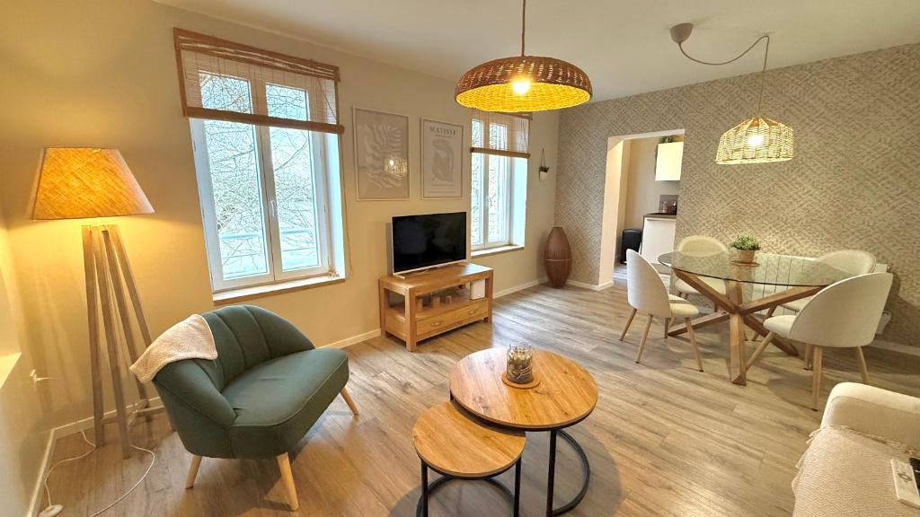 a living room with a couch and a table at Le Gingko in Montmerle Sur Saône