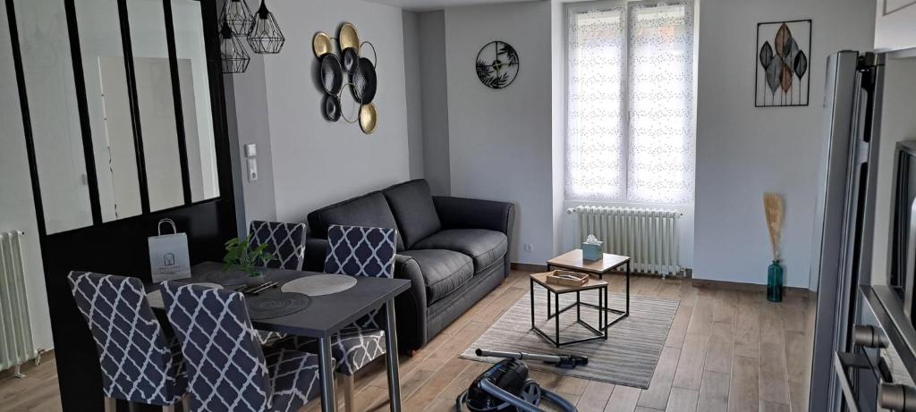 a living room with a couch and a table at Maison Au 14 in Tours-sur-Marne