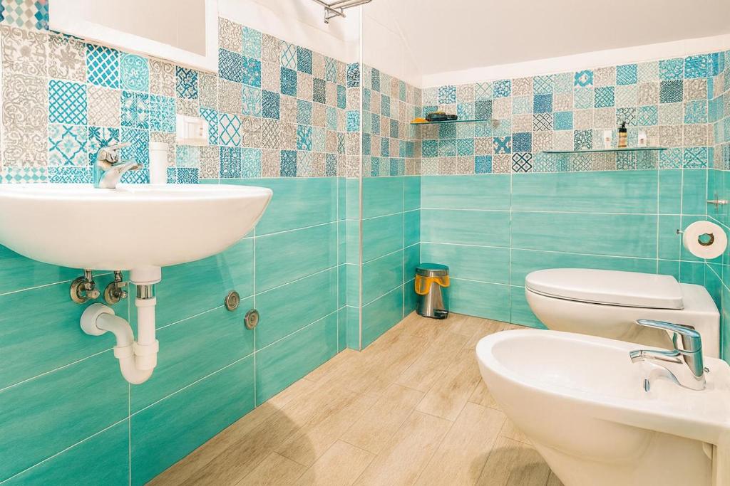 a bathroom with a sink and a toilet at Villa Antonietta Ischia in Ischia