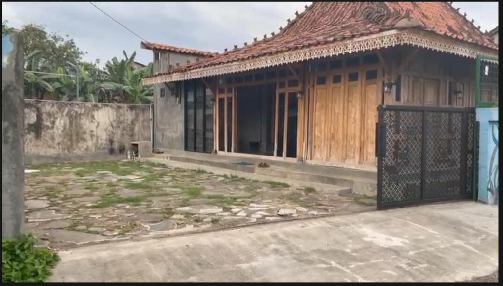 a house with a gate in front of it at Omah Masayu in Yogyakarta