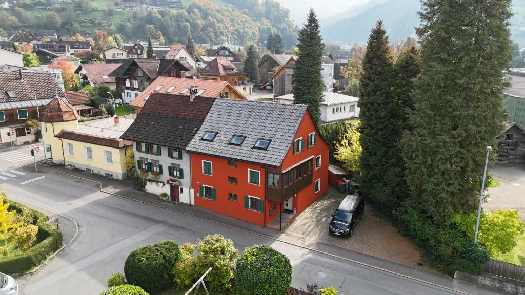 an aerial view of a town with a red house at S12 Dornbirn, Vorarlberg Apartments in Dornbirn