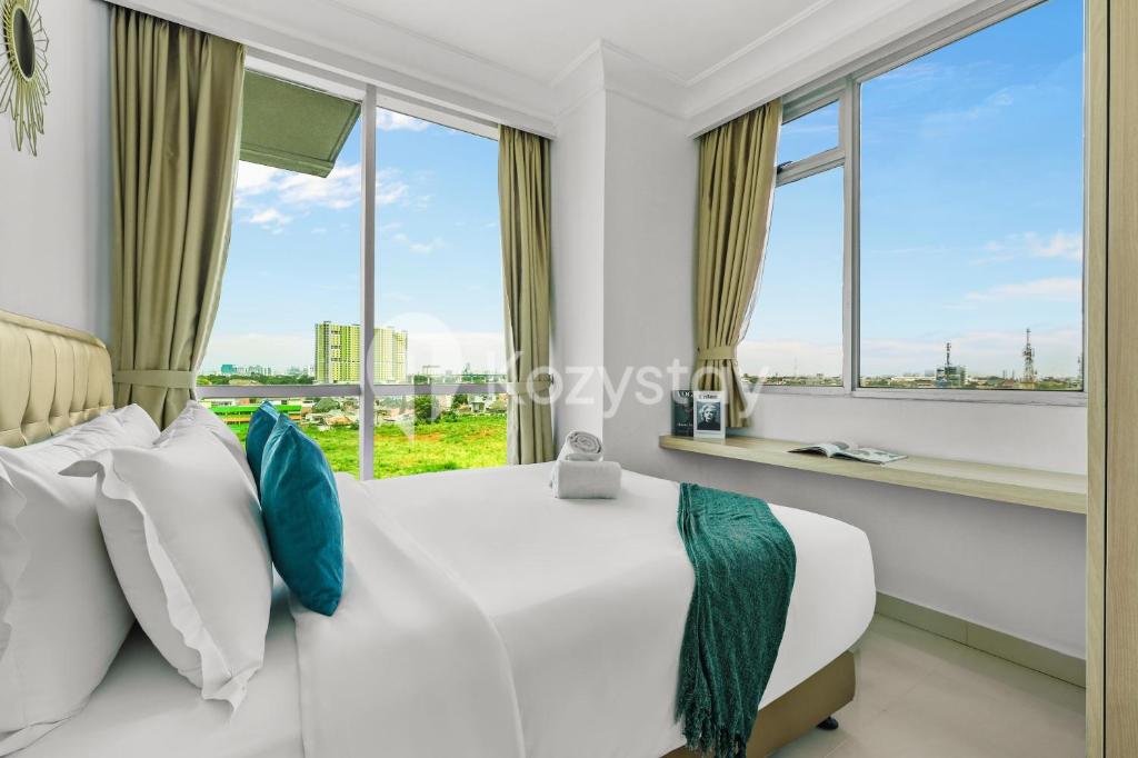 a bedroom with a view of the city at Lily by Kozystay - Kuningan in Jakarta