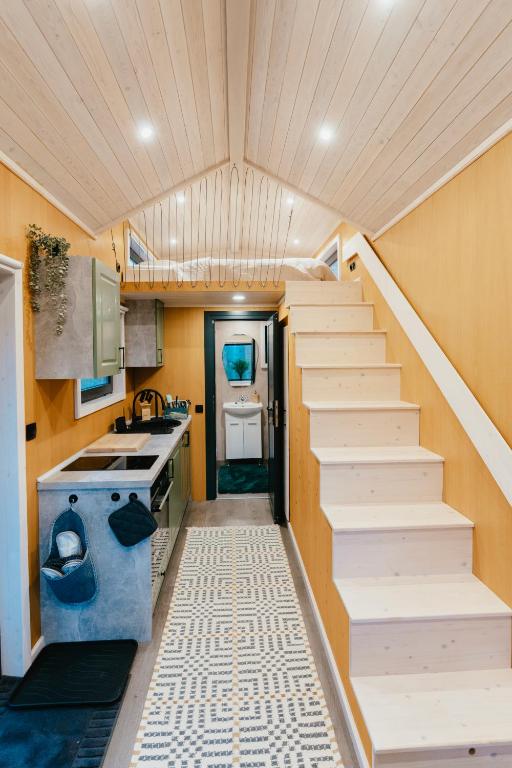 a staircase in a tiny house with a kitchen at Dreambox South Kerry in Sneem