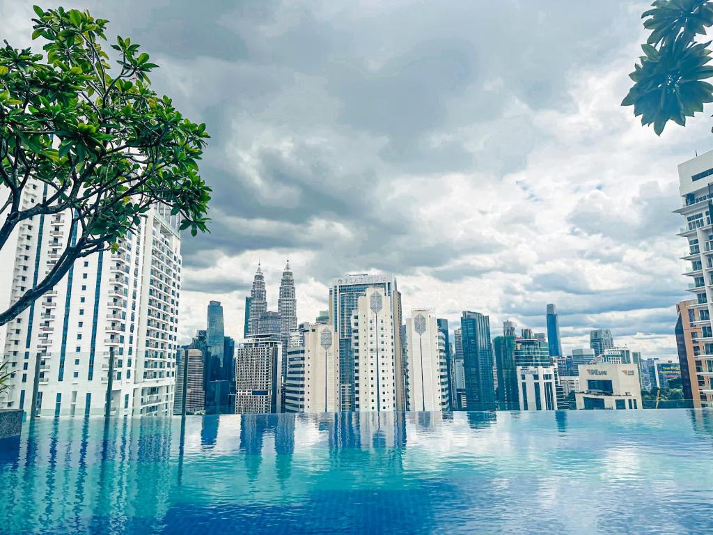 a view of a city skyline from a swimming pool at Majestic Residence KLCC By Homestay in Kuala Lumpur