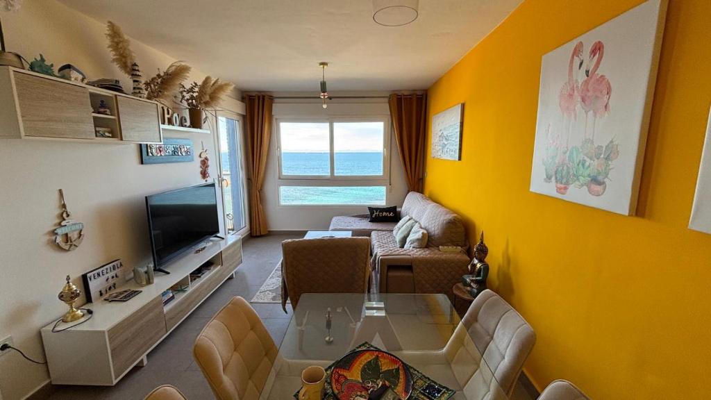 a living room with a couch and a television at VENEZIOLA PARADISE, spa & gym in La Manga del Mar Menor