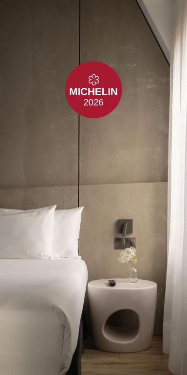 a hotel room with a bed and a sign on the wall at Hotel Tayko Bilbao in Bilbao