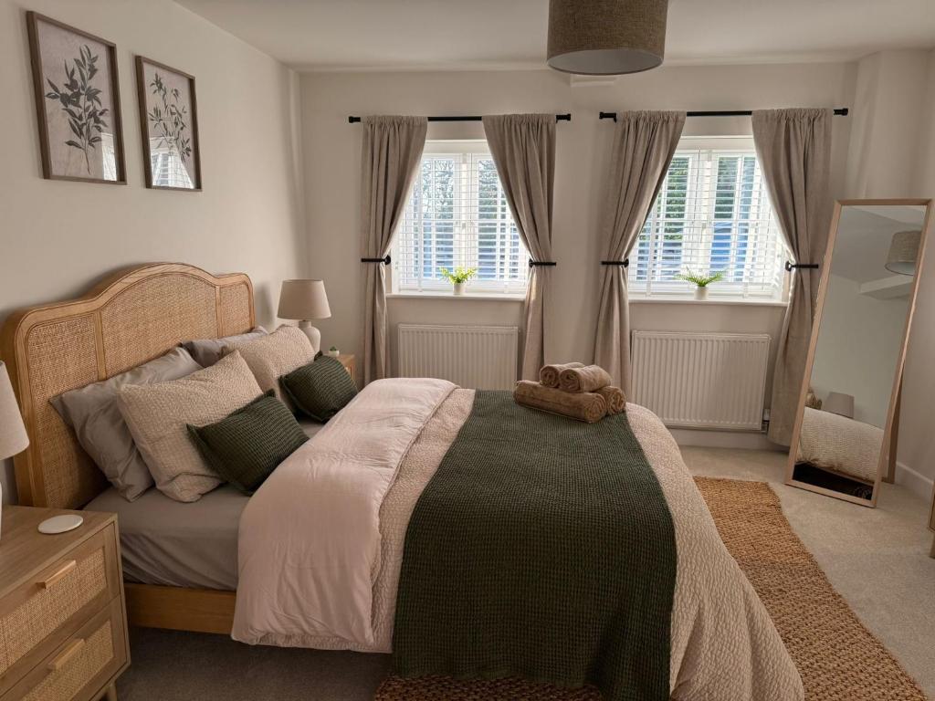 a bedroom with a bed with a teddy bear on it at Luxury Lechlade cottage - Character and charm in Lechlade
