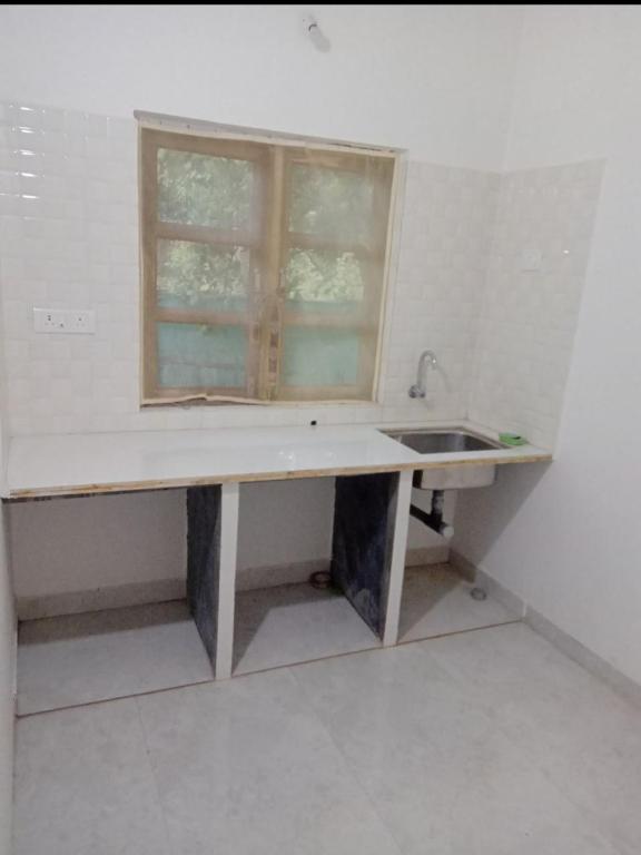 a kitchen with a sink and a window at Budha Garden in Arambol