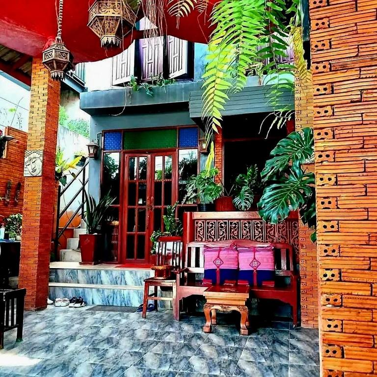 a group of benches in front of a building at Baan Cozy Boutique Natural Wellness Chiang Mai in Chiang Mai