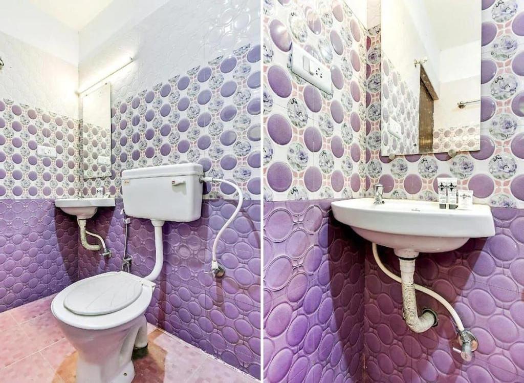 a purple bathroom with a toilet and a sink at LIMRA INN RESIDENCY cottage in Ooty