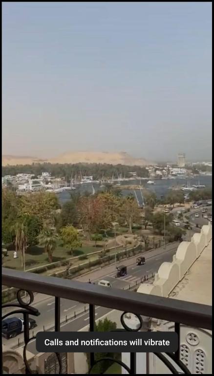 a view of a city from a balcony with a street at Flat in Nag` el-Ramla