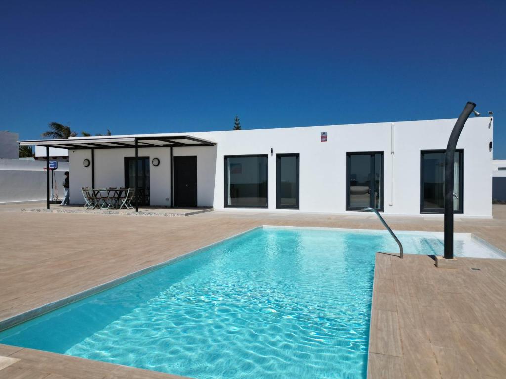 a swimming pool in front of a building at Villa Mare in Teguise
