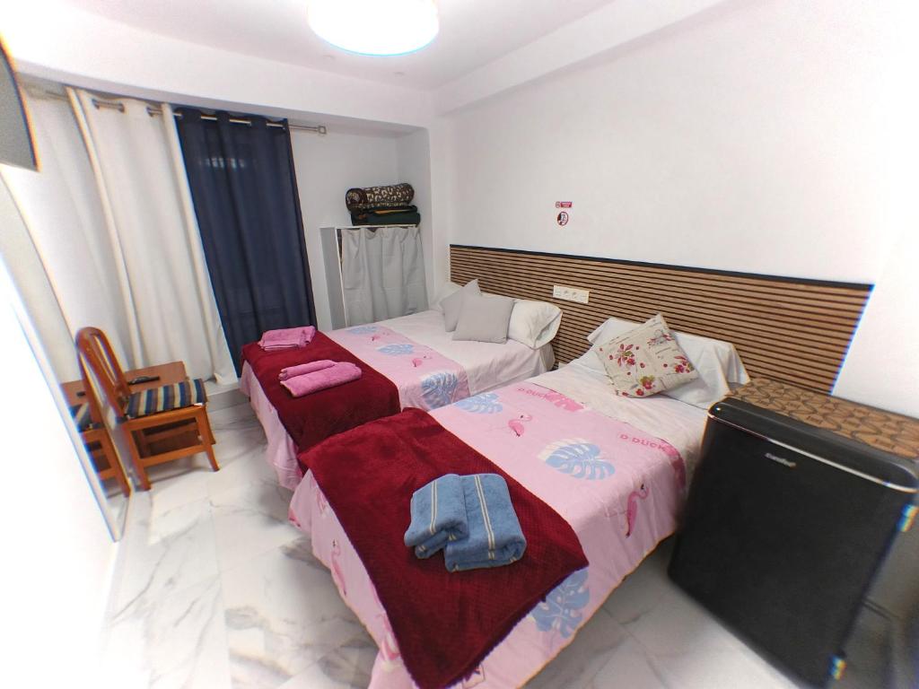 En eller flere senge i et værelse på Pensión Múgica