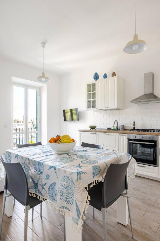 a kitchen with a table with a bowl of fruit on it at Casa Gaeta in Gaeta
