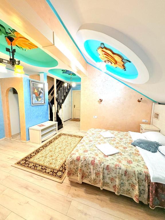 a bedroom with a bed with a painting on the ceiling at Presidential Apartment in Suceava