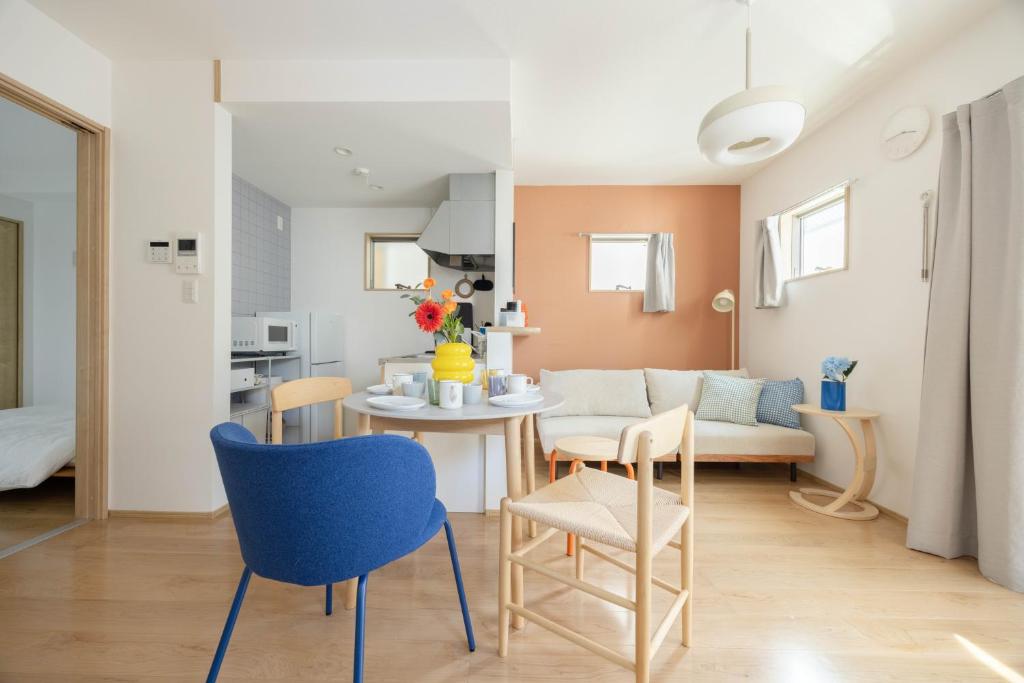 a kitchen and living room with a table and chairs at Nagoya Hanezu in Nagoya