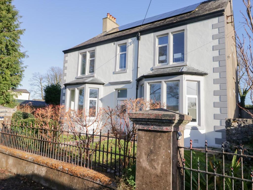 ein weißes Haus mit einem Zaun in der Unterkunft Rocklands in Shap