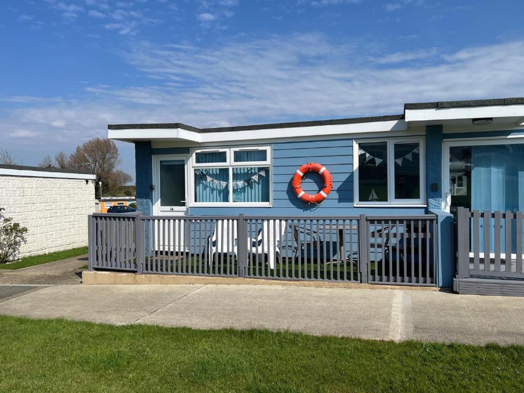 a blue tiny house with a red life preserver at Wight Waves Holidays in Sandown