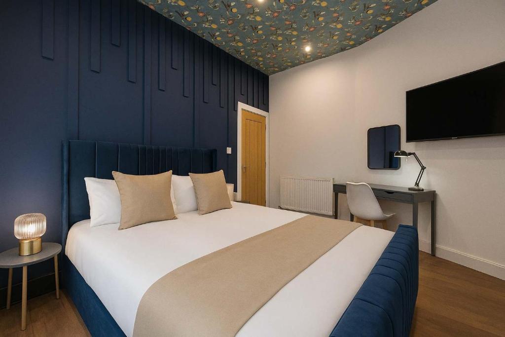 a bedroom with a large bed and a tv at The Carlton Heights by The HIve WA1 in Warrington