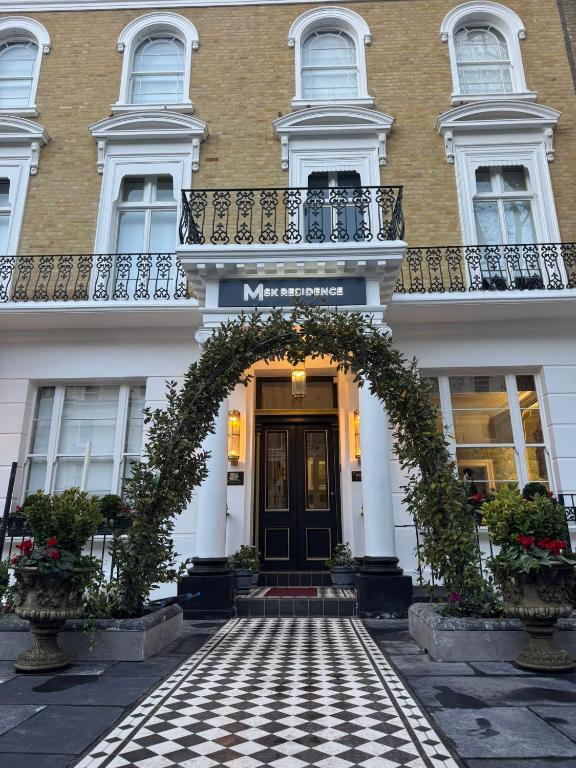 an entrance to a building with an arch in front of it at MSK The Whiteley in London