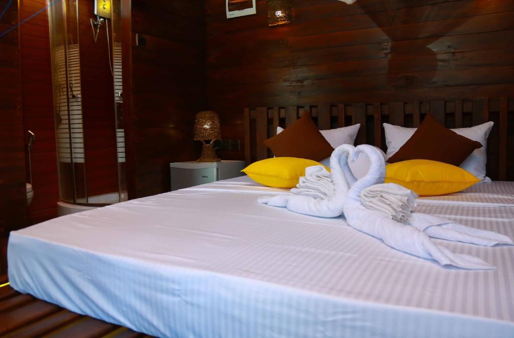 Postel nebo postele na pokoji v ubytování Coco Palm Villa and Cabanas