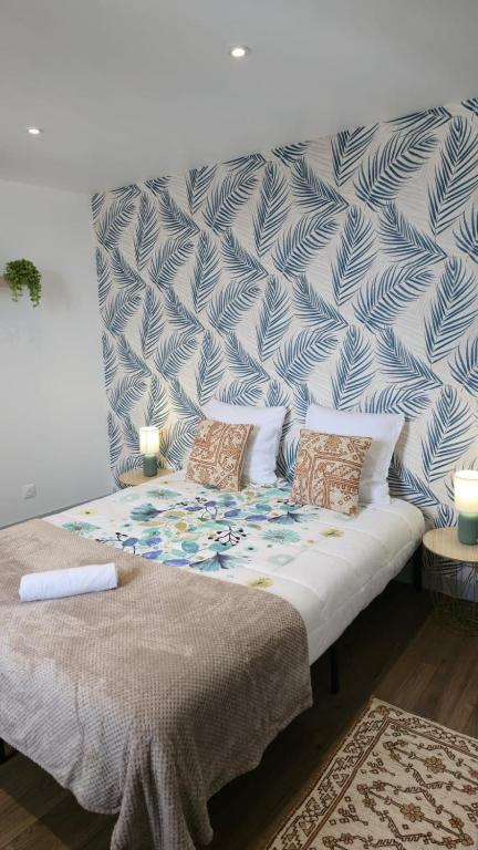 a bed with two pillows on it in a room at Le Comte de Saxe - Calme à Blois centre in Blois
