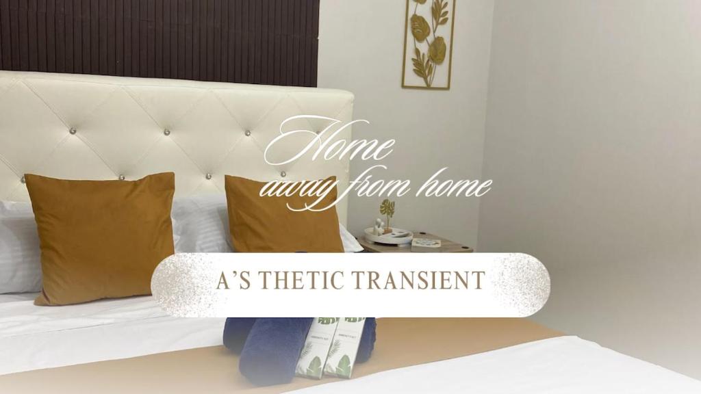 a bedroom with a white bed with a white headboard at As Thetic Transient in San Pablo