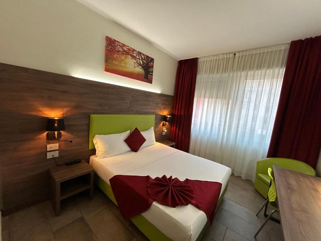 a bedroom with a bed and a table in a room at Hotel Stradivari in Milan