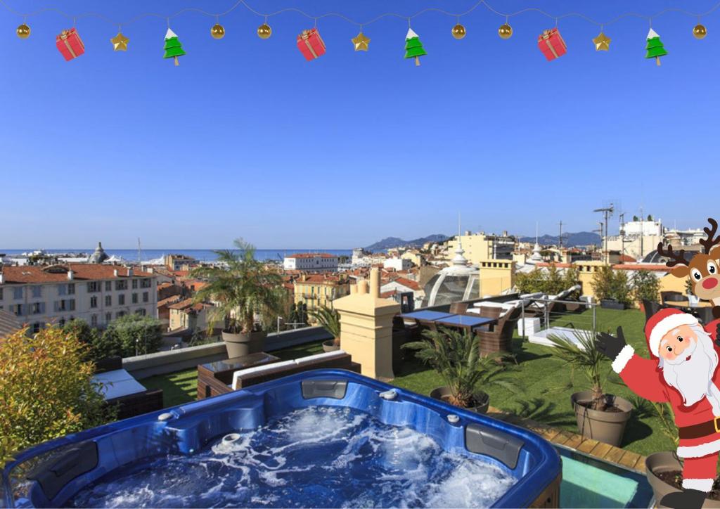 a hot tub on a balcony with christmas decorations at Residence du Louvre - Apartments - Prime location Palais & Croisette - Luxury Stay by LRA Cannes in Cannes