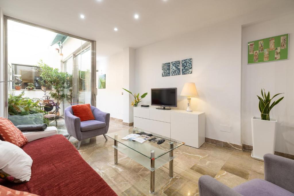 a living room with a couch and a tv at Ca Se Predine by Rentallorca in Alcudia