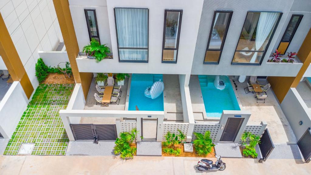 an overhead view of a building with a pool at hiii Aura Pool Villa Hotel Pattaya Central in Pattaya Central