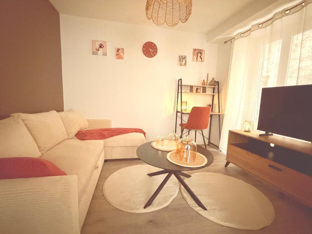 Boulieu-lès-AnnonayAppartement cosy et lumineux的客厅里有一张白色的沙发和一张桌子
