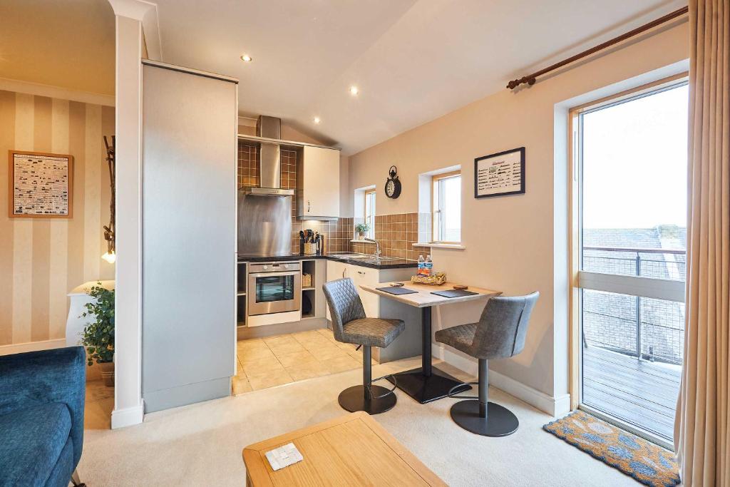 a kitchen with a table and chairs in a room at Host & Stay - The Shipshape in Seahouses