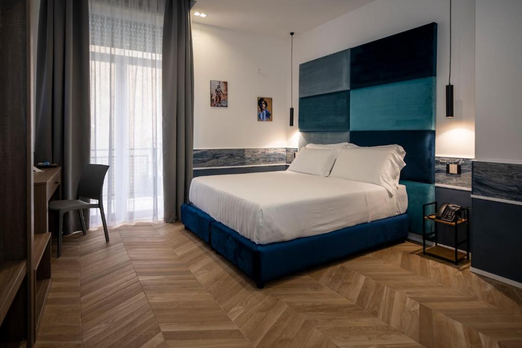 a hotel room with a bed and a desk and a desk at Hotiday Napoli Maradona in Naples