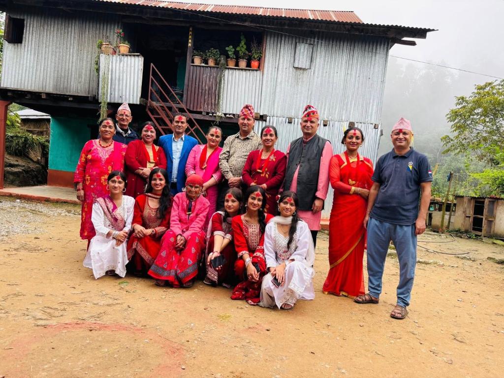 a group of people posing for a picture in front of a house at Thir bahadur karki's Home 