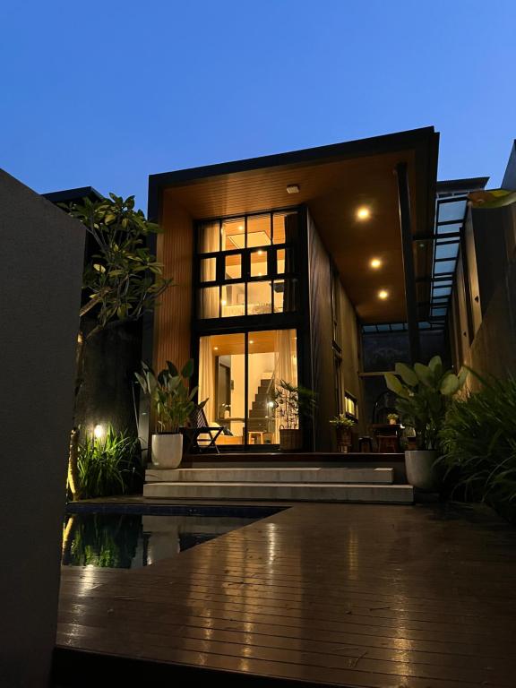 a house with a large window in front of it at Breezia Villa Mezzanine with Private Pool in Blimbing