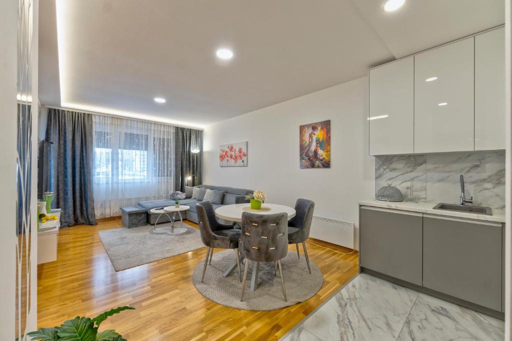 a kitchen and living room with a table and chairs at Vip Jovan 83 in Zlatibor