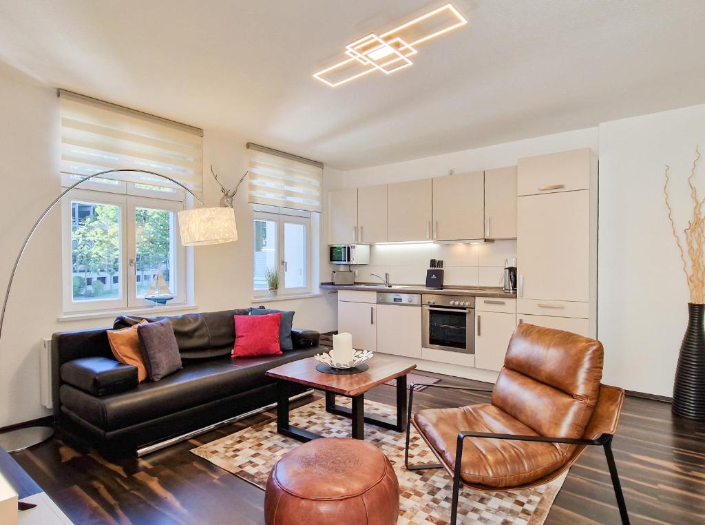 a living room with a couch and a table at Brise Villa Emmi App 03 in Heringsdorf