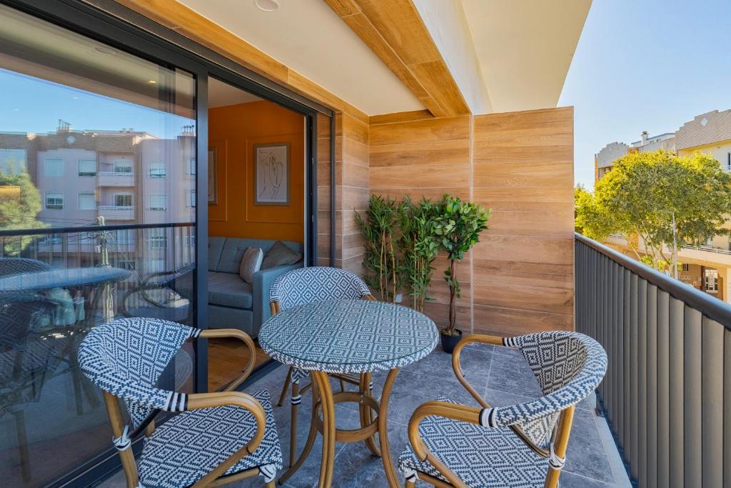 a balcony with tables and chairs on a balcony at Quinta View Apartment, By Home Match in Setúbal