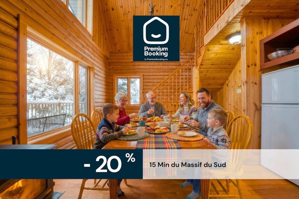 a group of people sitting around a table in a room at Chalet Aigle 7 min to SPA for 16 Guests , Skiing in Saint-Paul-de-Montminy