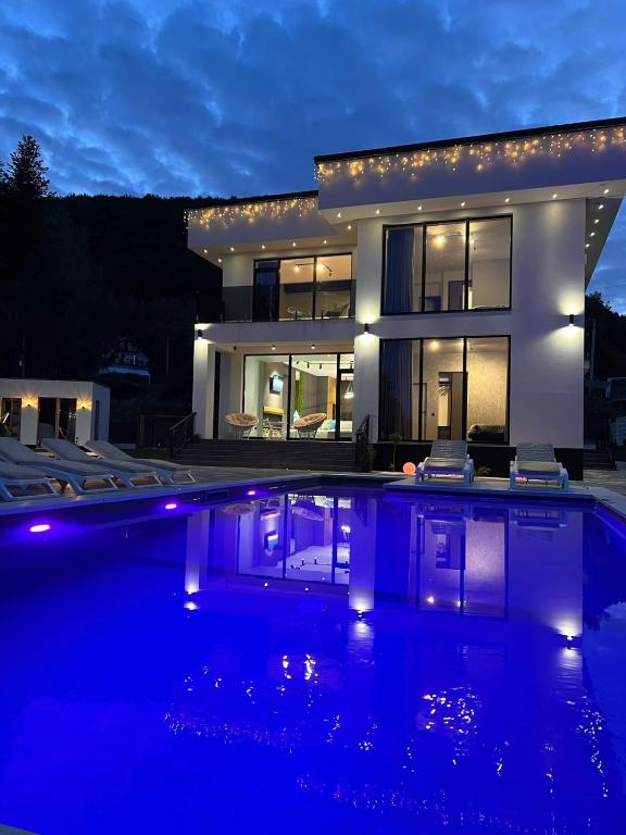 a large house with a swimming pool at night at Monte Blu in Migovo