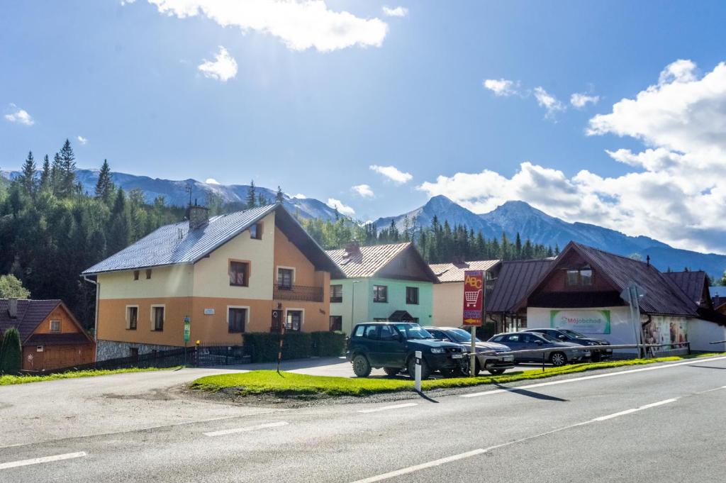 a street with cars parked in front of a house at Apartmán Otília in Ždiar