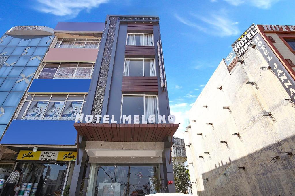 a hotel melion building with a sign on it at Hotel Melano Ambala Chandigarh Rd Zirakpur SkyJumper park in Zirakpur